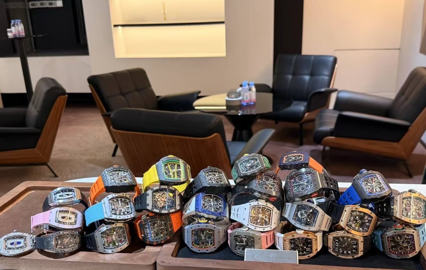 A close-up of pre-owned watches laid out for inspection at WATCHMILL